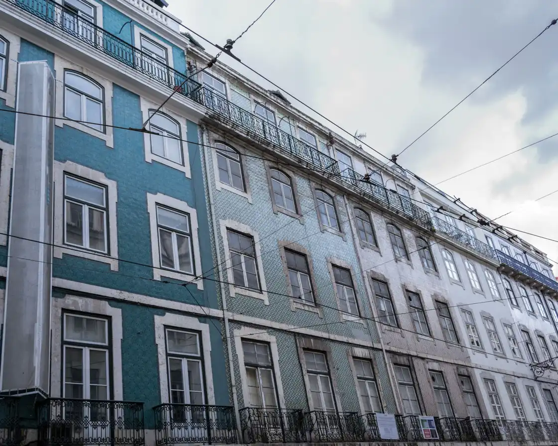 A tiled façade in Lisbon seen from the street at a low angle