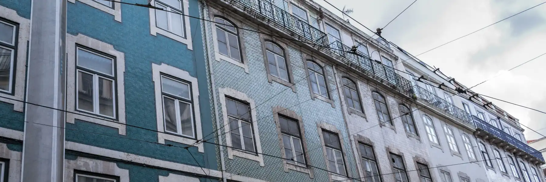 A tiled façade in Lisbon seen from the street at a low angle